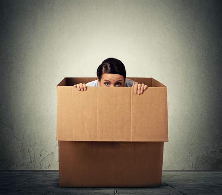 43705172 - young woman hiding in a carton box