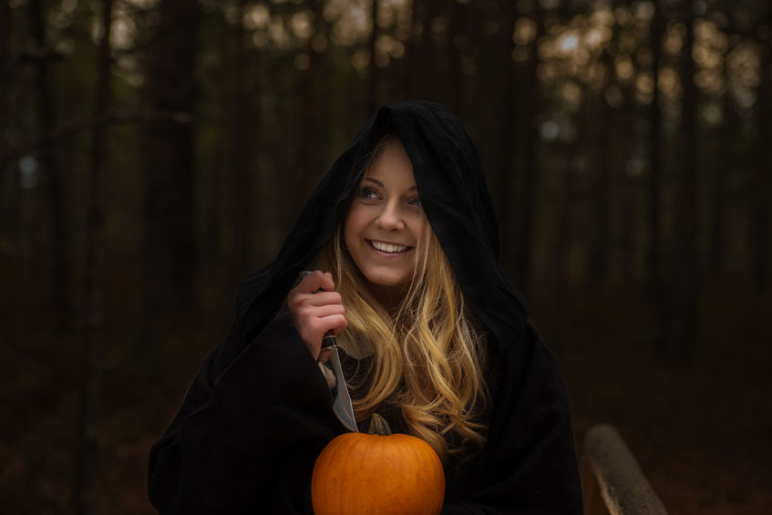 47656781 - young woman in halloween witch costume in the autumn forest with yellow pumpkin. toning photo