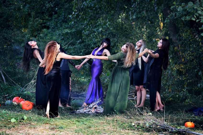 62219687 - young beautiful witches dancing in the forest holding hands