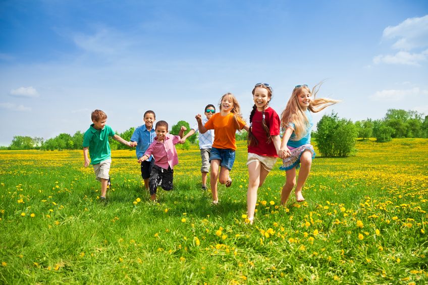 20981386 - large group of kids running in the dandelion spring field