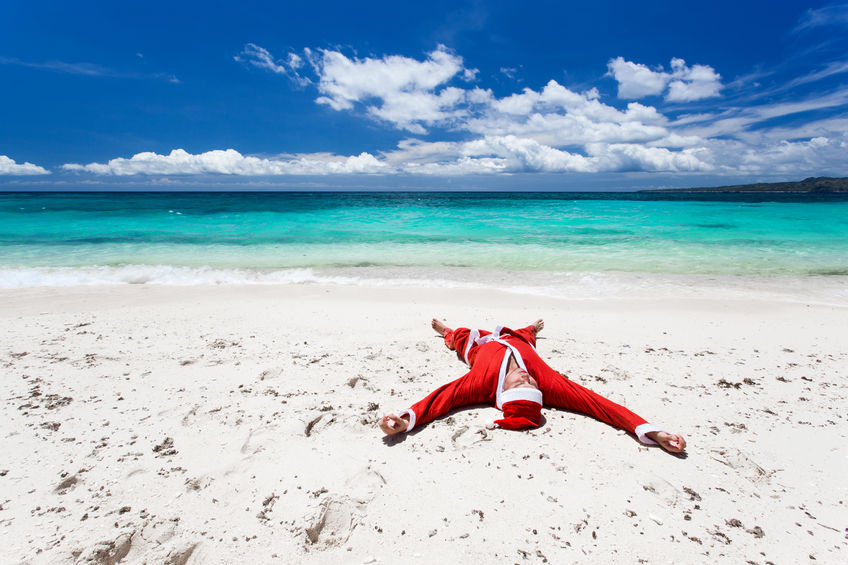 23321703 - santa claus on beach relaxing, enjoying summer