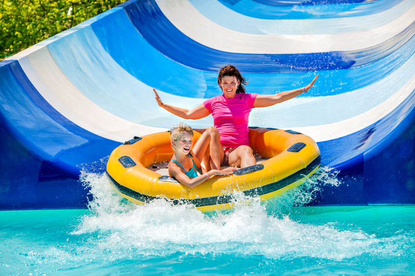 40456807 - child with mother on water slide at aquapark. two persons on summer holiday.