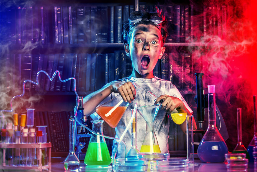 44696348 - a boy doing experiments in the laboratory. explosion in the laboratory. science and education.