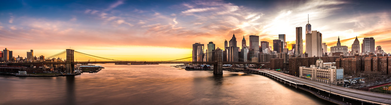 45882424 - brooklyn bridge panorama at sunset. the iconic landmark spans between brooklyn and the new york financial district skyline, dominated by the freedom tower.