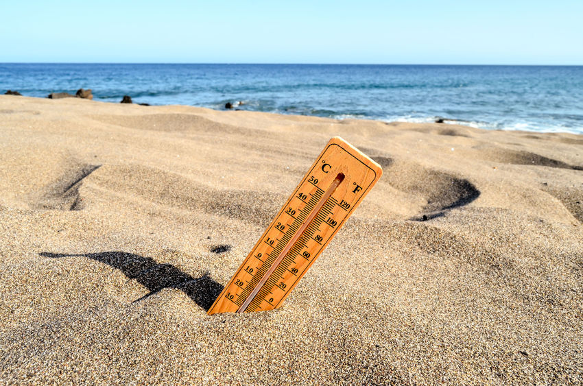 47286127 - photo picture of a thermometer on the sand beach