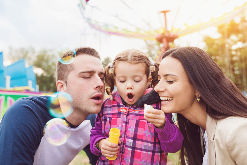 47410070 - beautiful young family enjoying their time at fun fair