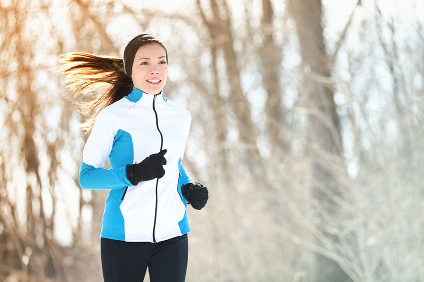 16604000 - running sport woman. female runner jogging in cold winter forest wearing warm sporty running clothing and gloves. beautiful fit asian / caucasian female fitness model.