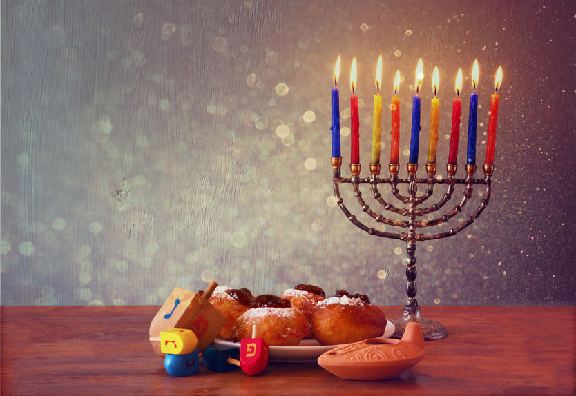 32926990 - jewish holiday hanukkah with menorah, doughnuts over wooden table. retro filtered image