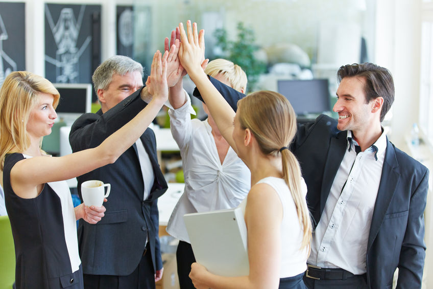 39539640 - happy business team making high five with their hands in the office