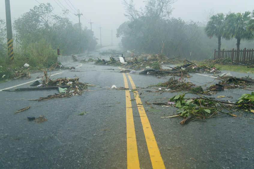 44728466 - debri blocking road during a typhoon