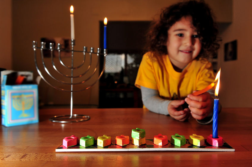 46257022 - jewish girl is lighting the first candle for the jewish holiday of hanukkah. hanukkah or chanukah, chanukkah, or chanuka, also known as the festival of lights, is an eight-day jewish holiday. hanukkah is observed for eight nights and days.