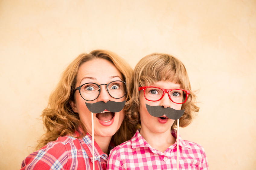 46594231 - mother and child with fake mustache. happy family playing in home