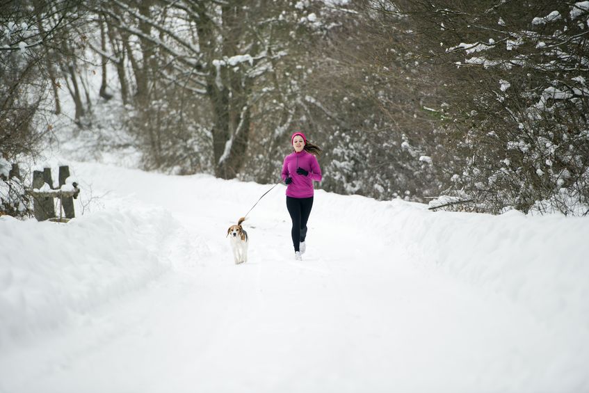 17593741 - athlete woman is running during winter training outside in cold snow weather.