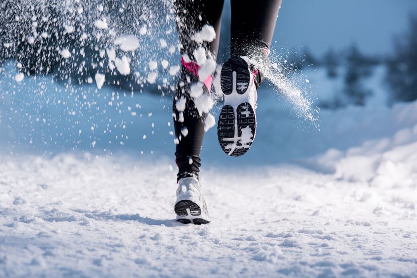 21226091 - athlete woman is running during winter training outside in cold snow weather