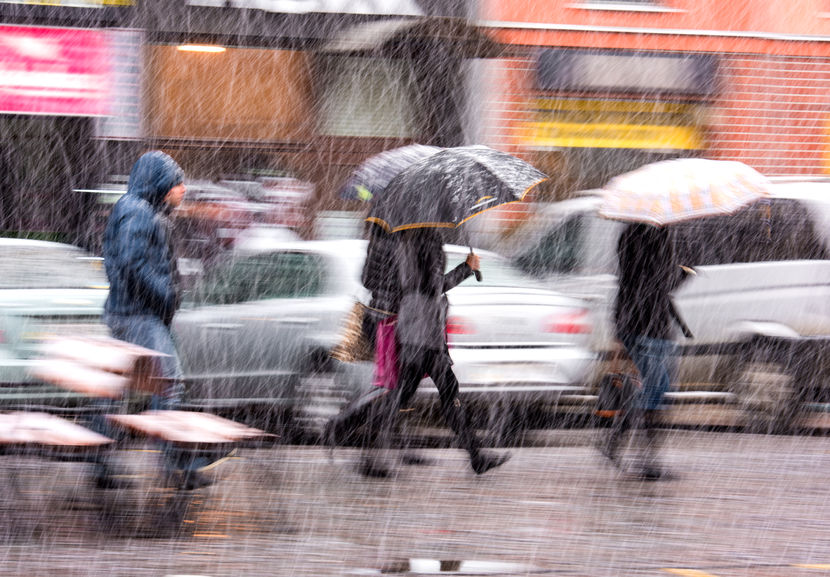 36868471 - people walking down the street in a snowy winter day in motion blur