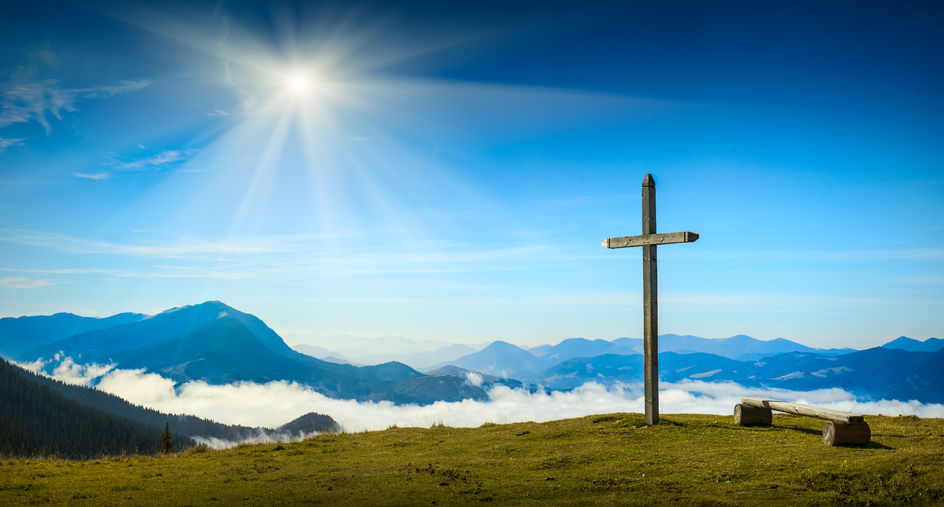 38328541 - place for rest with christian cross on a top of mountain above the sunny foggy valley. carpathian mountains, ukraine.