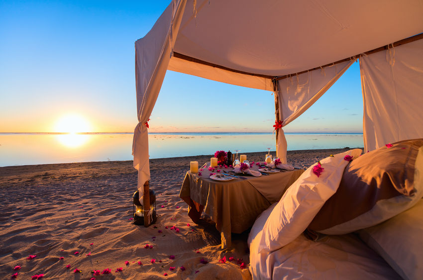 43858578 - romantic luxury dinner setting at tropical beach on sunset