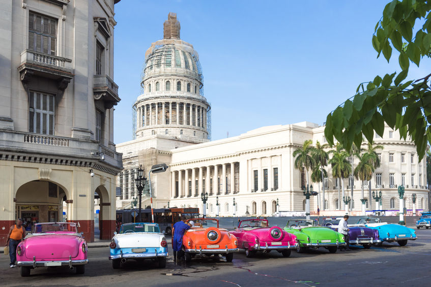 44187273 - many colorful american oldtimers parked in series in havana with view of the capitol