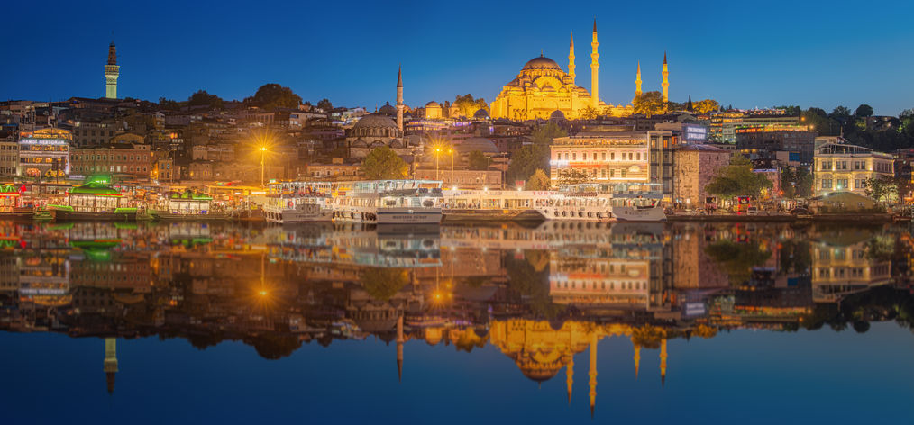 45716330 - istanbul skyline from galata bridge by night, with suleymaniye mosque and fish boat ferry