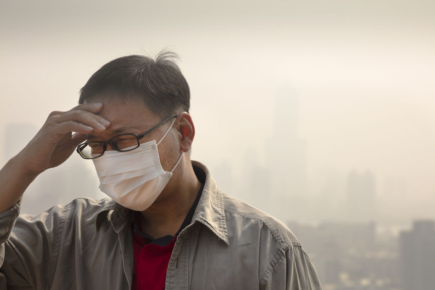48387435 - asian man wearing mouth mask against air pollution