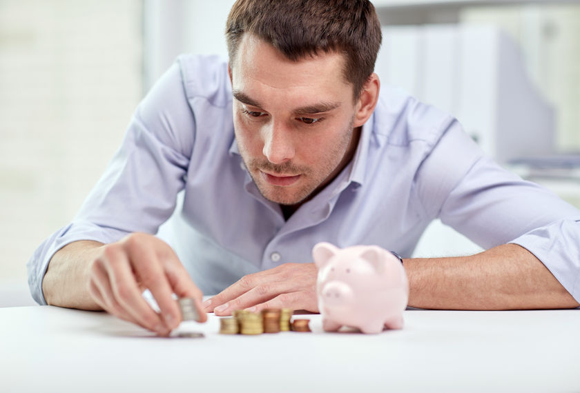 49042569 - business, people, finances and money saving concept - businessman with piggy bank and coins at office