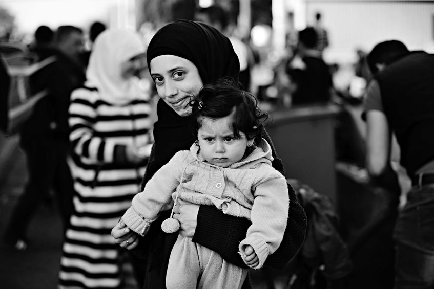 53737464 - october 6,2015; hegyeshalom in hungary. group of refugees leaving hungary. they came to hegyeshalom by train and then they leaving hungary and go to austria and then to germany. many of them escapes from home because of civil war.
