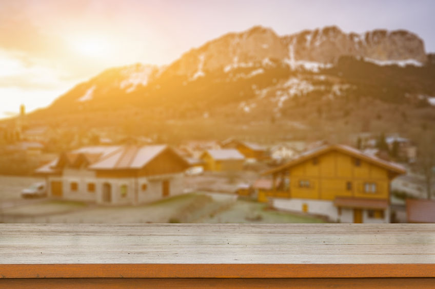 66428045 - empty brown wooden table top on blurred background of mountain ski resort with snow in winter,quaint village in the swiss alps during winter  - can be used for display or montage your products