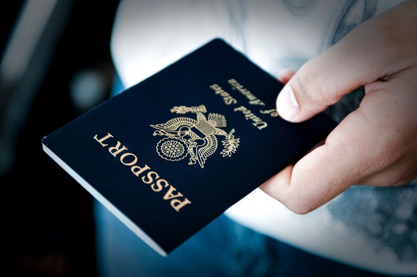 10313003 - image of a persons hand holding a passport