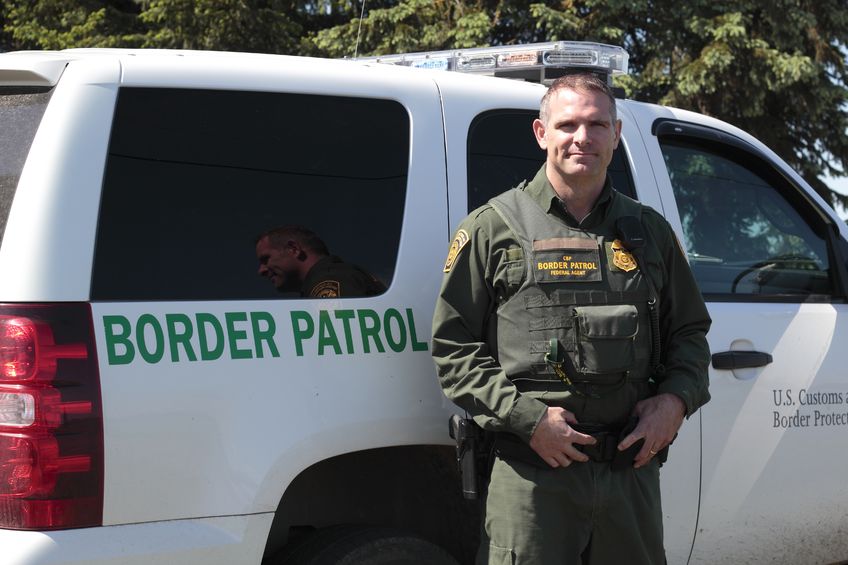 13789572 - united states border patrol officer and vehicle