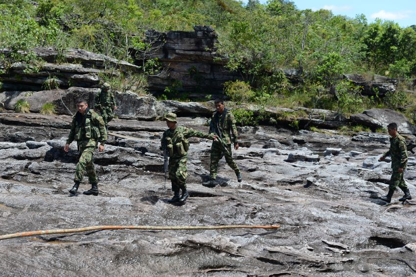 23583486 - la macarena, colombia-november 6  military forces of colombia supervise territories where guerrillas of farc still act soldiers patrol the mountain river in november 6; 2012 in la macarenia;colombia