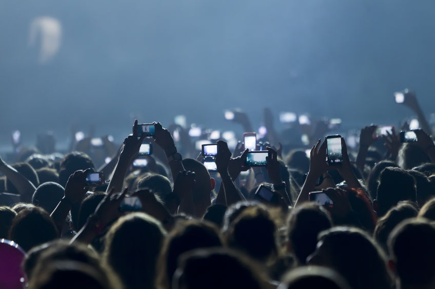 28230565 - people taking photographs with touch smart phone during a music entertainment public concert