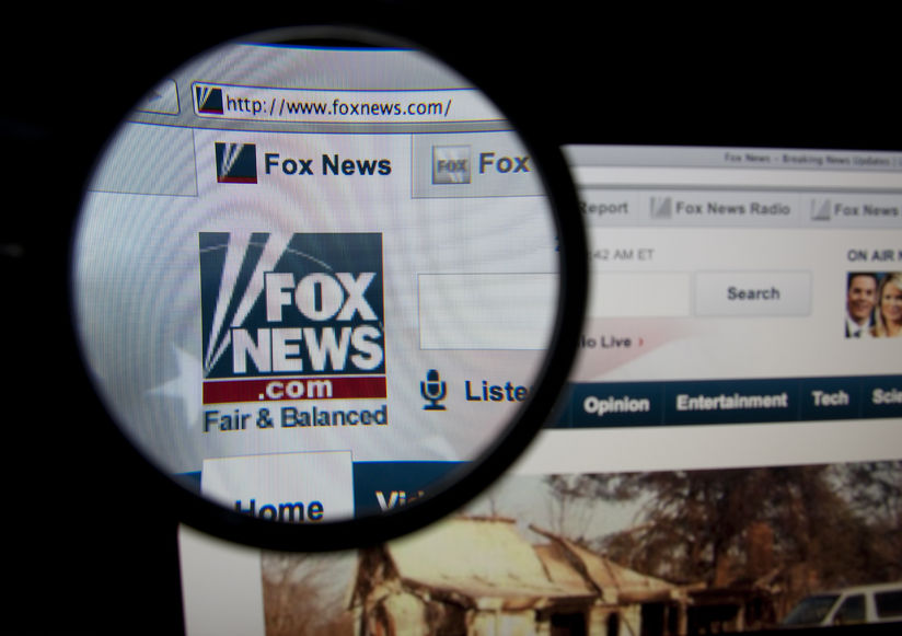 34840960 - lisbon, portugal - february 5, 2014: photo of fox news homepage on a monitor screen through a magnifying glass.