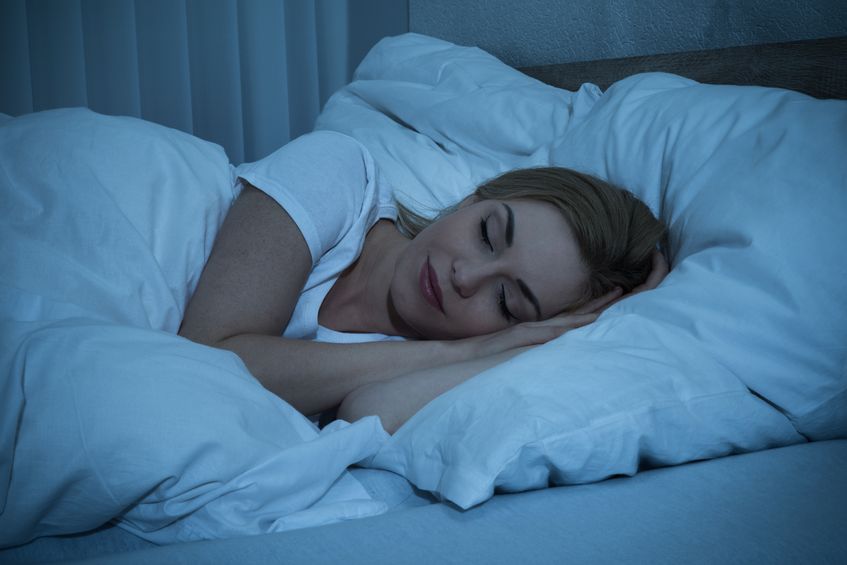 43306299 - young woman with blanket sleeping at night in bed