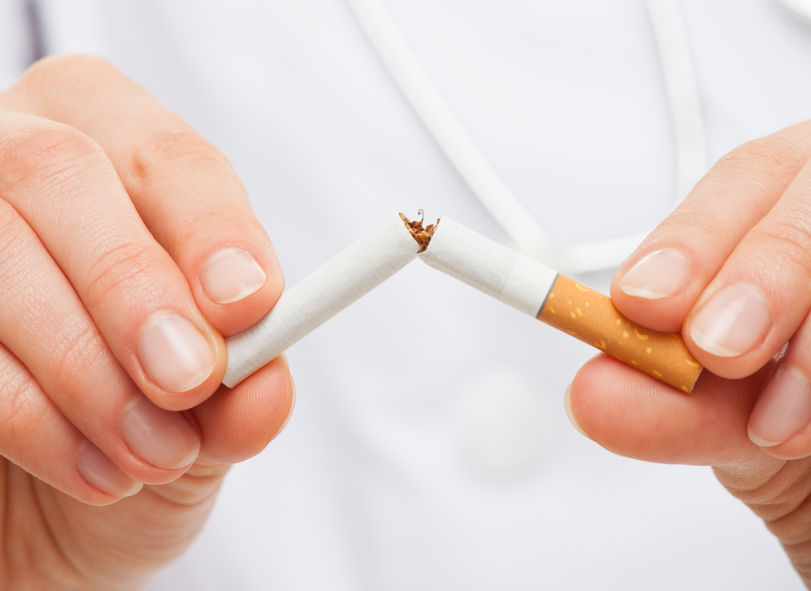 47934558 - doctor's hands holding a broken cigarette, healthy lifestyle concept