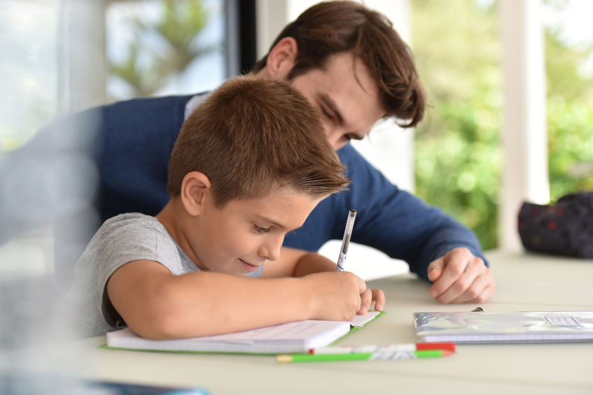 50356079 - man helping son with homework