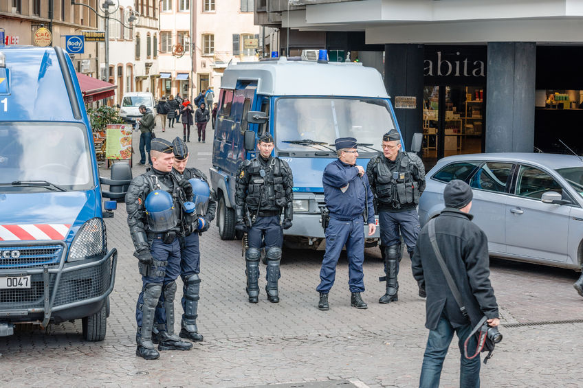 53419735 - strasbourg, france - 9 mar 2016: police officers surveilling street as thousands of people demonstrate as part of nationwide day of protest against proposed labor reforms by socialist government