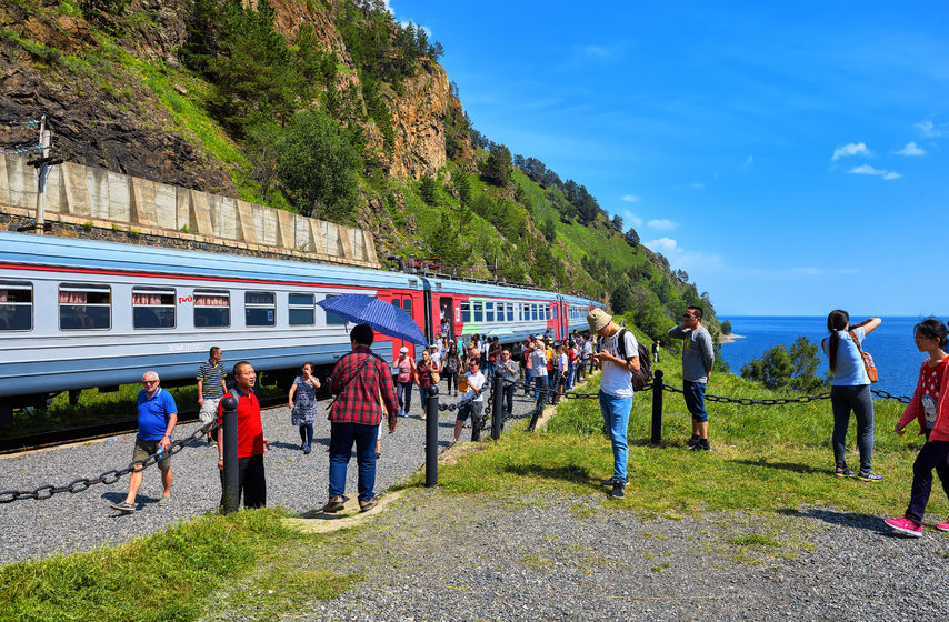 68595185 - kirkirey, irkutsk region, russia - july, 29,2016: baikal express. tourists from different countries visiting sights of circum-baikal railway. stopping 123 kilometer - a place of joining trans-siberian railway in 1904