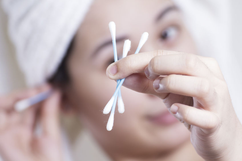 27734388 - lady holding several cotton buds for cleaning the ears. close up.