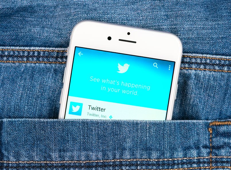 33601582 - simferopol, russia - november 11, 2014: silver apple iphone 6 in jeans pocket displaying twitter application. twitter is an online social networking service that send and read messages