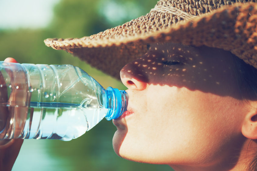46616588 - woman drinking water in summer sunlight