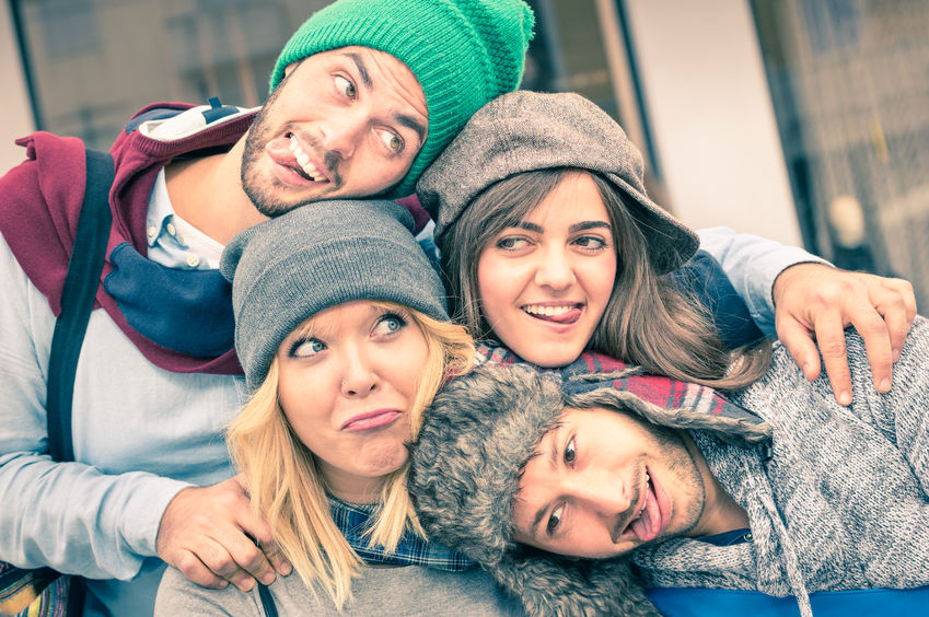 47923668 - group of best friends taking selfie outdoors with funny face expression and fashion clothes - happy friendship concept with young hipster people having fun together - vintage desaturated filtered look