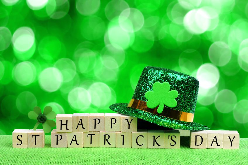 52420134 - happy st patricks day wooden blocks with leprechaun hat and shamrock over twinkling green background
