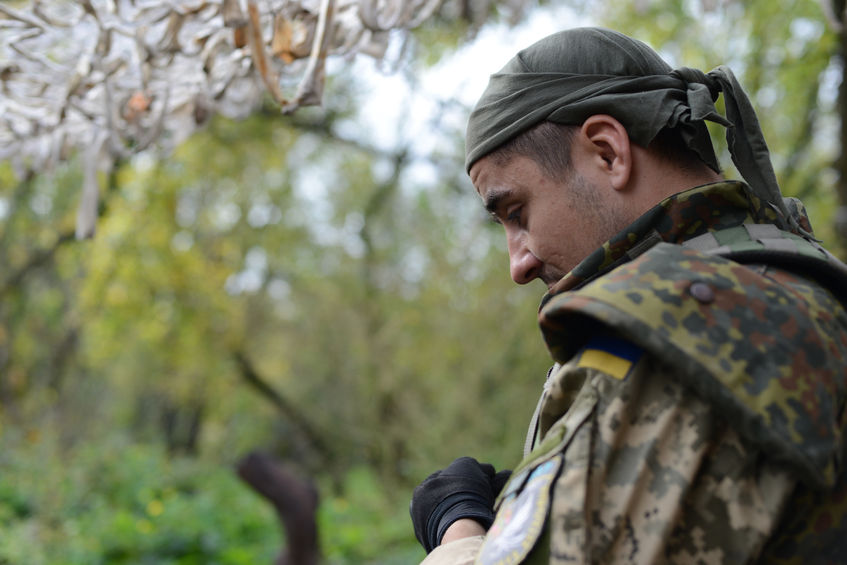 64741406 - the war in ukraine. army soldier ukrainian sad looking down. glory to ukraine!