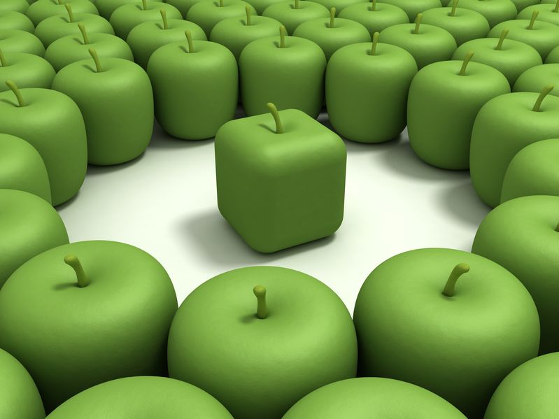 11888030 - green apple of the cubic form in an environment of usual green apples.