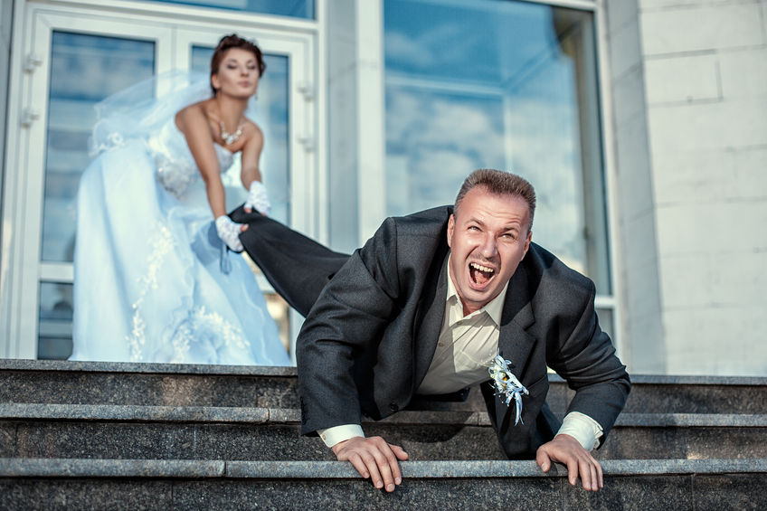 28578079 - bride leg pulls groom at the wedding