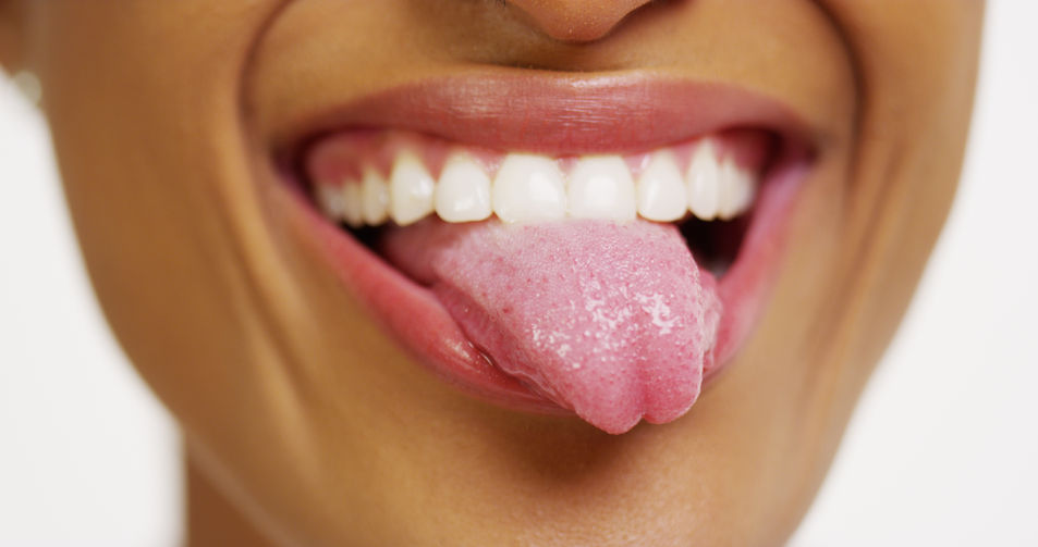 33766358 - close up of african woman with white teeth smiling and sticking tongue out