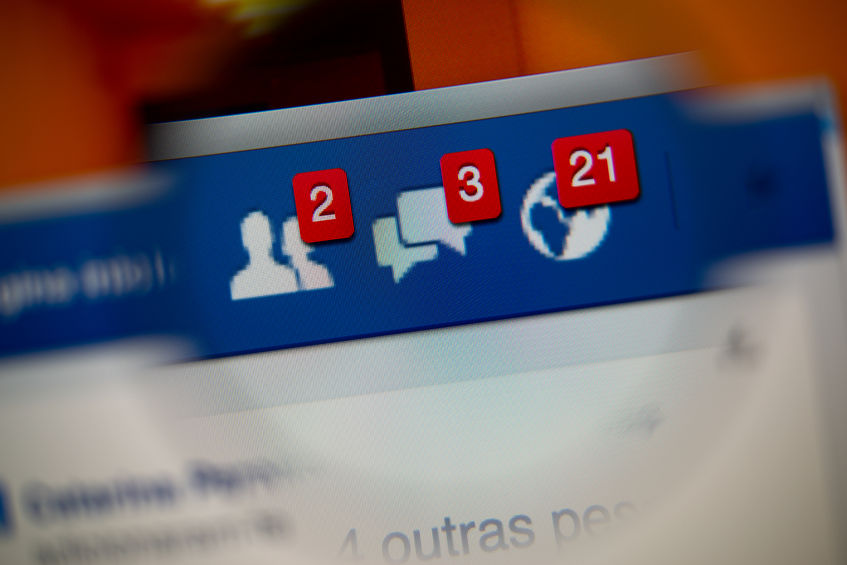 34848963 - lisbon, portugal - august 27, 2014: photo of facebook alerts of friend requests, messages inbox and notifications on a monitor screen through a magnifying glass.