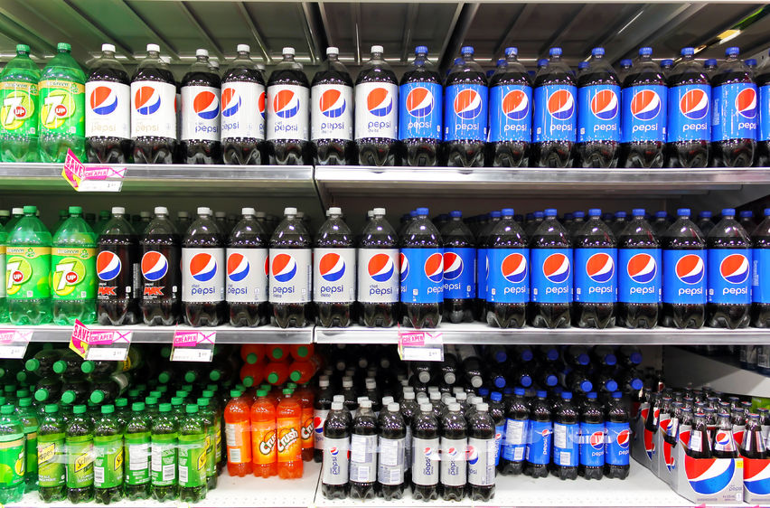 38140412 - bottled soft drinks on shelves in a supermarket
