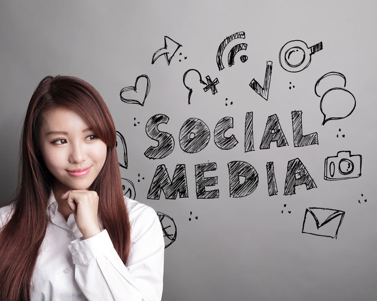 40856199 - social media concept - business woman look social media text and icon on grey background, asian
