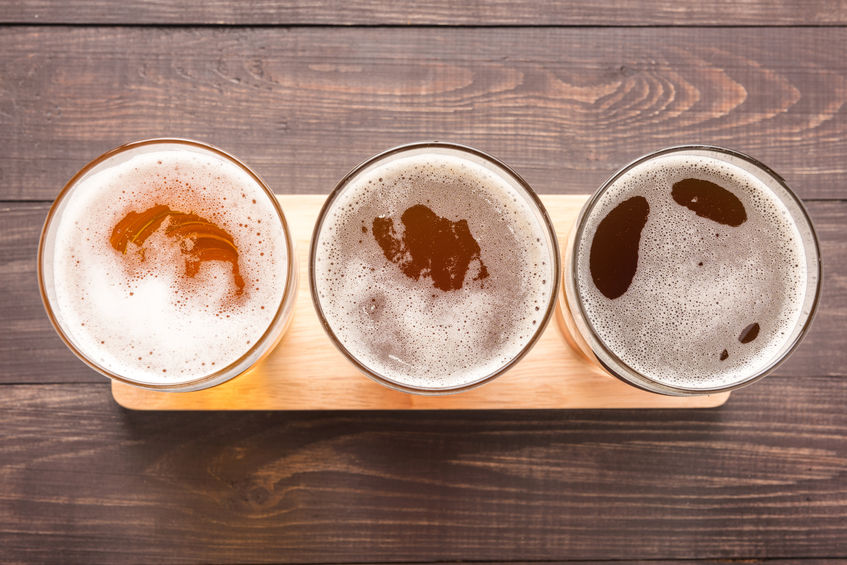 46644467 - assortment of beer glasses on a wooden background. top view.